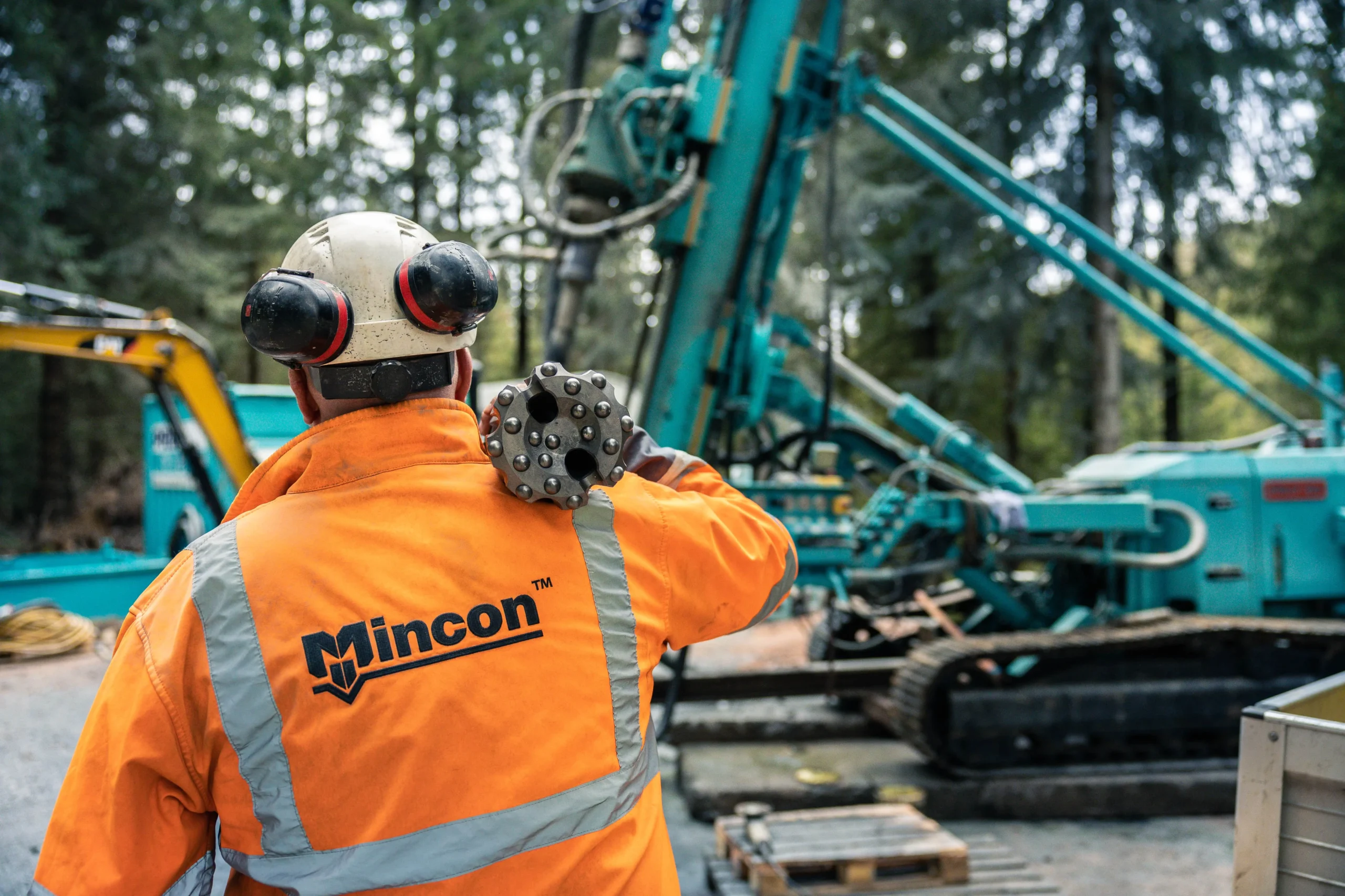 Mincon field operator carrying APEX RC drill bit for exploration drilling