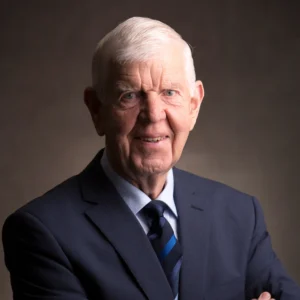Patrick Paddy Purcell, founder of Mincon, pictured in a formal portrait wearing a suit and tie