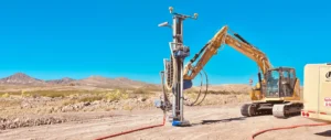 Mincon drill mast attachment for solar mounted on a CAT excavator drilling pile foundations at a utility-scale solar construction site