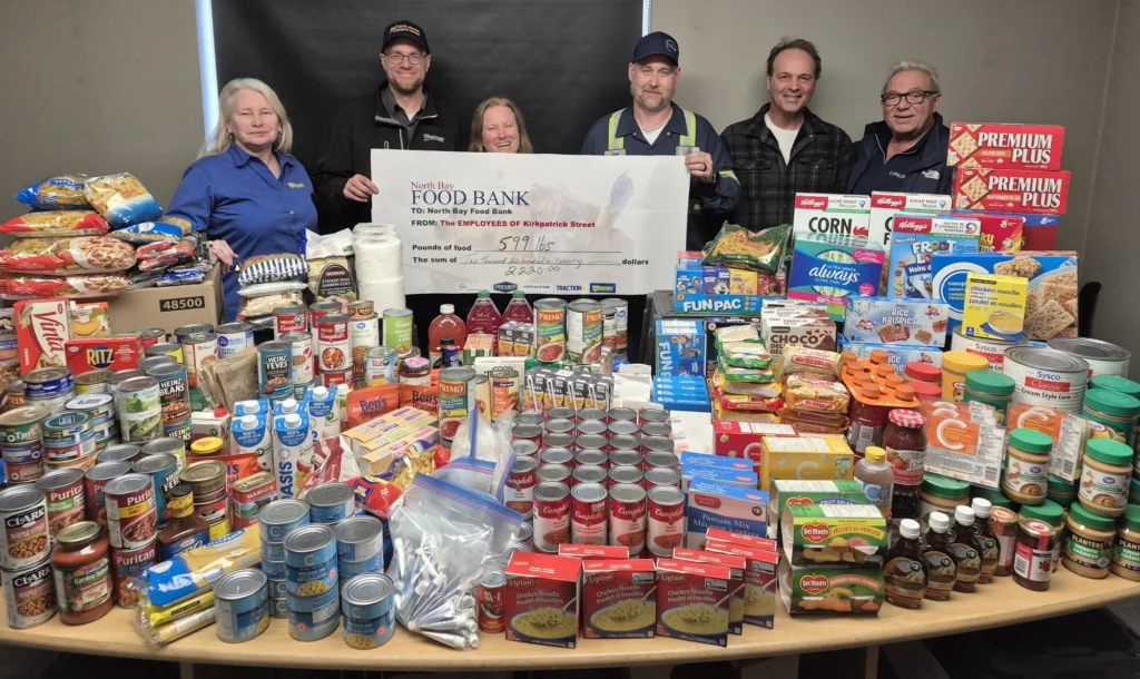 Mincon Canada team presenting a record North Bay Food Bank cheque for 599 lbs of food and $2,220