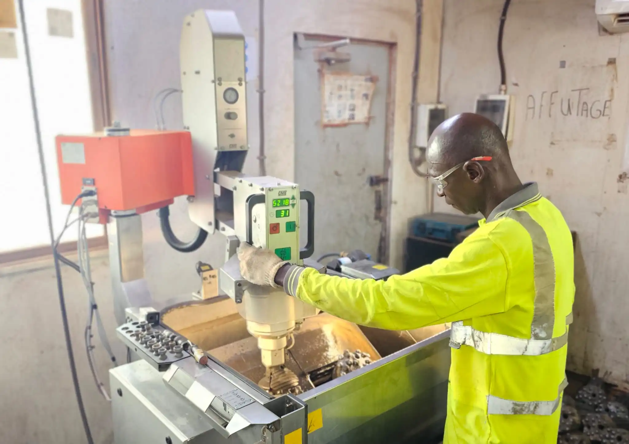 Worn Mincon drill bit carbide inserts being inspected for sharpening to restore penetration efficiency