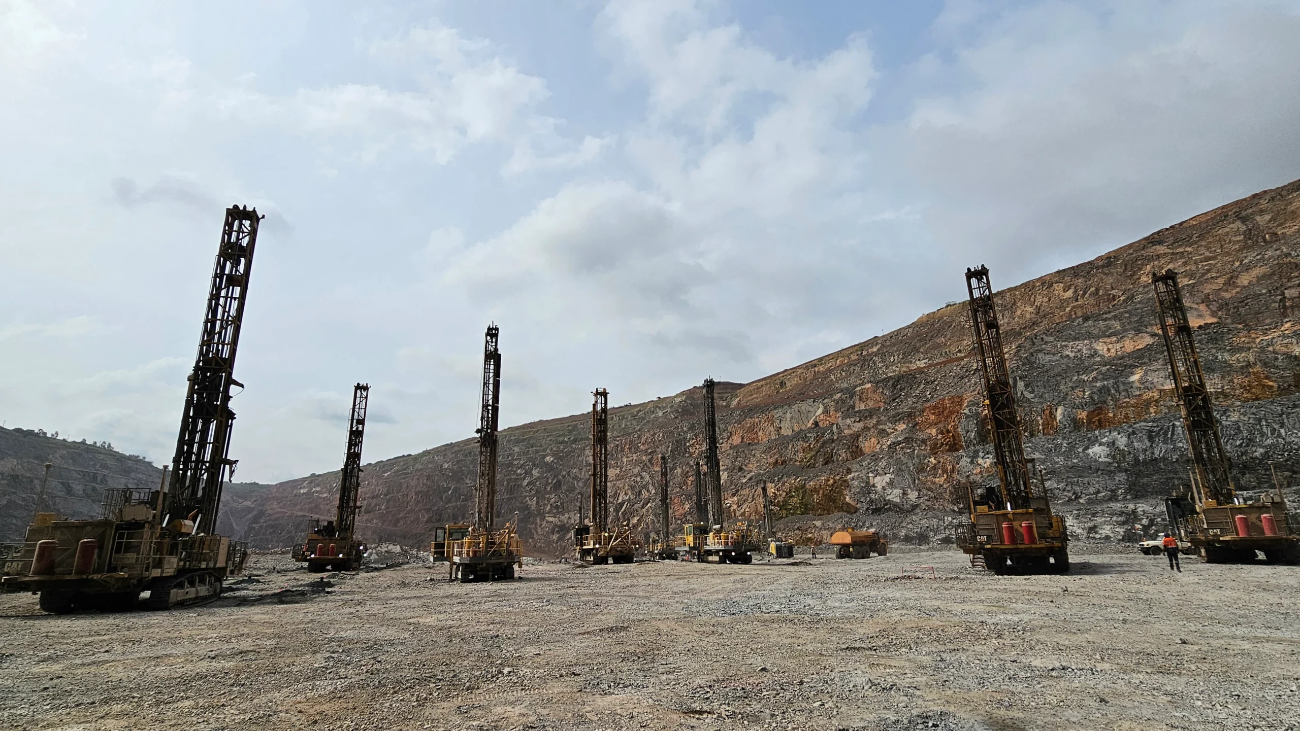 Blast-hole drill rig operating on a mine bench with Mincon DTH tooling optimized for the ground conditions