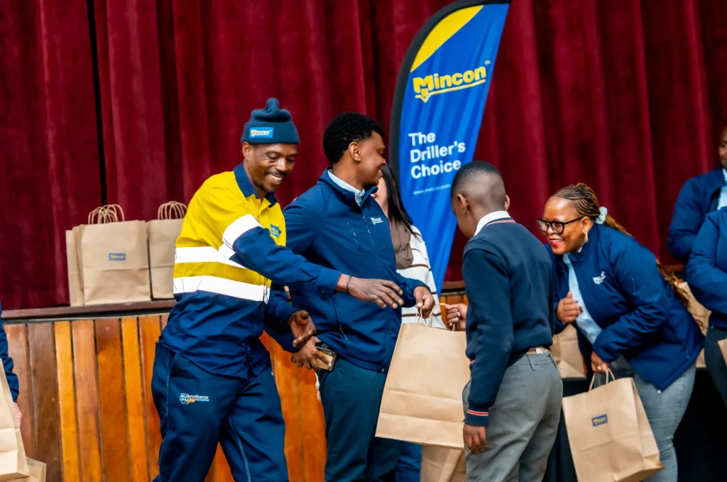 Mincon South Africa handing over school shoes as part of I Run So They Can Walk
